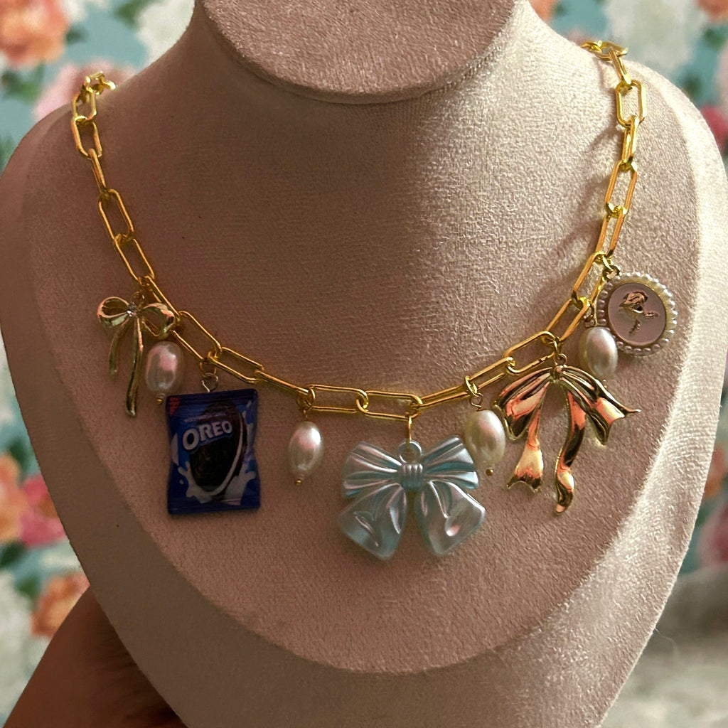 Pretty Gorgeous Stuff Bowie charm necklace with Oreo and bow charms close-up