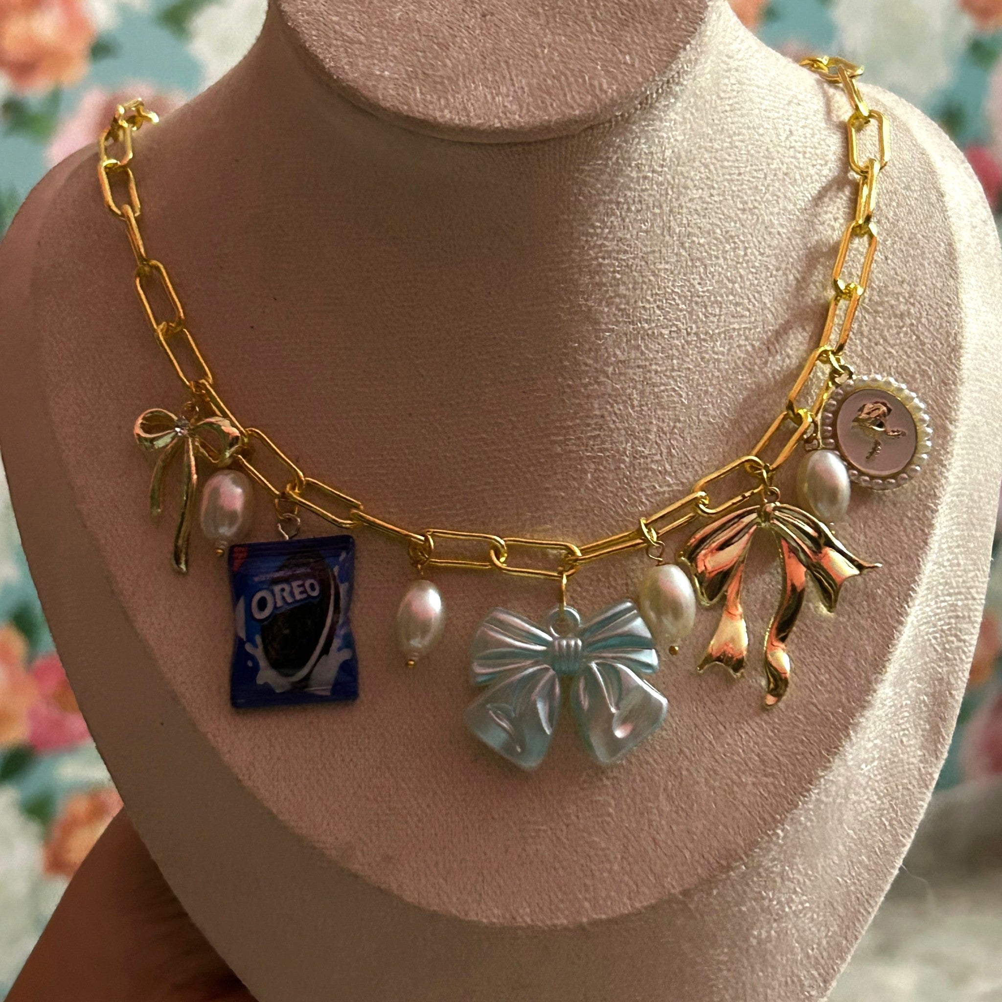 Pretty Gorgeous Stuff Bowie charm necklace with Oreo and bow charms close-up
