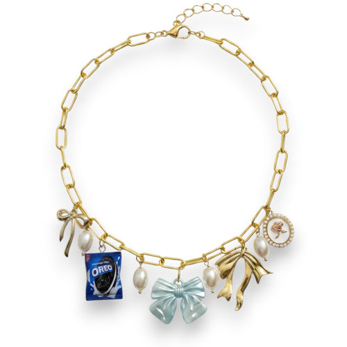 Pretty Gorgeous Stuff Bowie charm necklace with gold chain, pearl accents, and whimsical Oreo and bow charms.