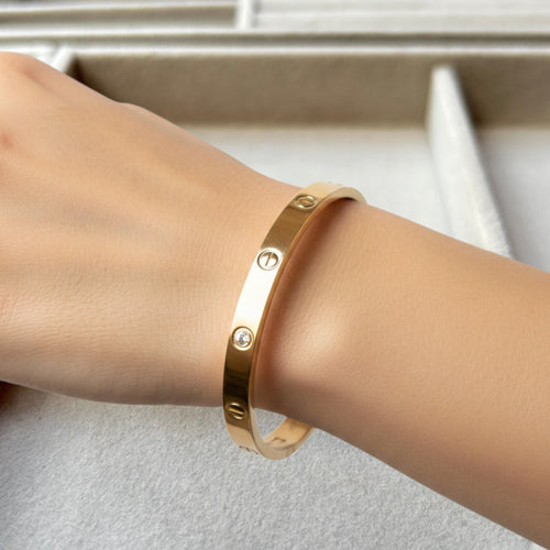 Pretty Gorgeous Stuff gold-plated alloy cuff bracelet featuring zirconia stones on a woman's wrist