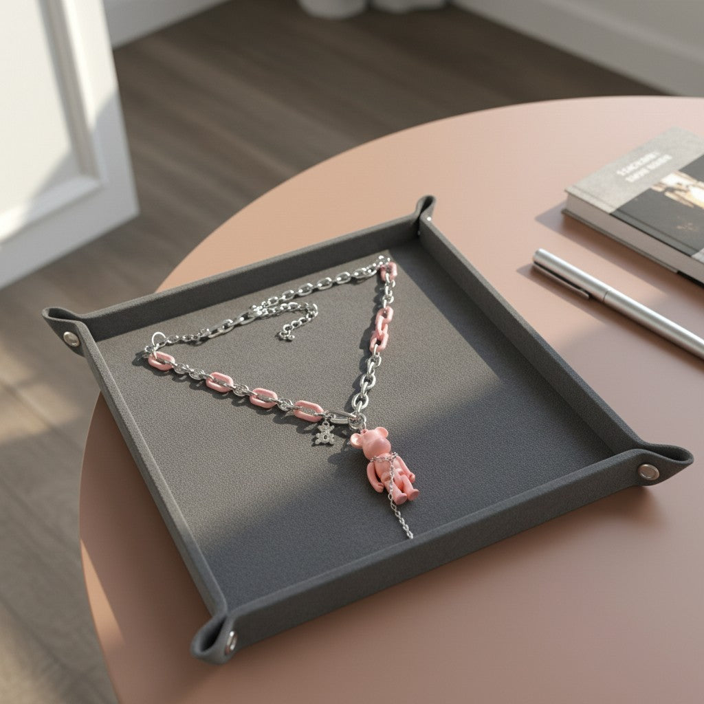 Pretty Gorgeous Stuff pink teddy bear pendant necklace with stainless steel and pink link chain on a grey tray