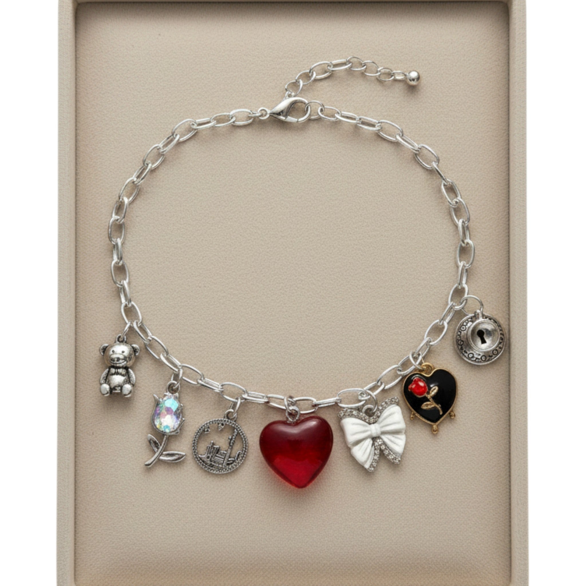 Pretty Gorgeous Stuff Sabrina charm necklace featuring silver chain with teddy bear, flower, heart, and bow charms.